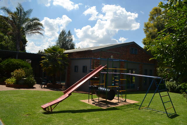 Garden playground with slide and swings