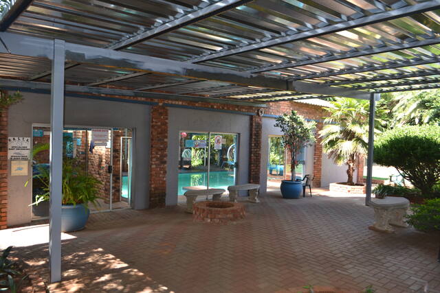 Covered patio area next to the pool