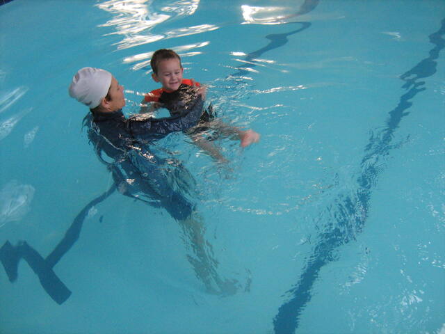 Instructor supporting a learner in the water
