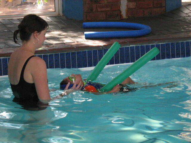 Instructor and learner with a pool noodle