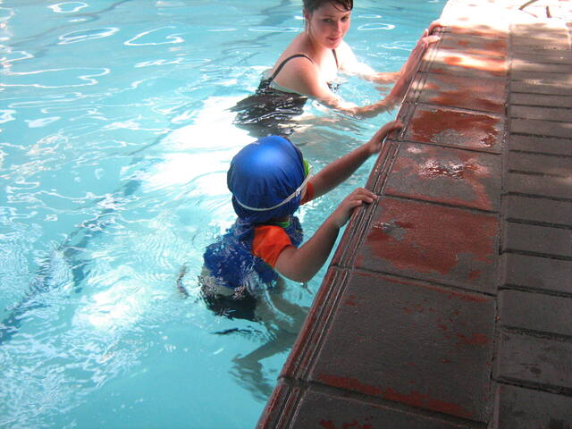 Learner holding the pool edge