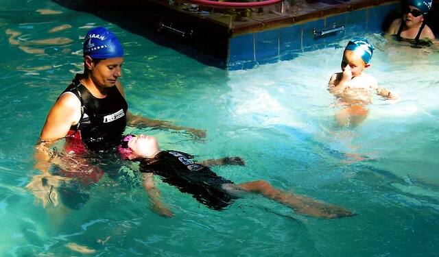 Instructor supporting a toddler in a back float